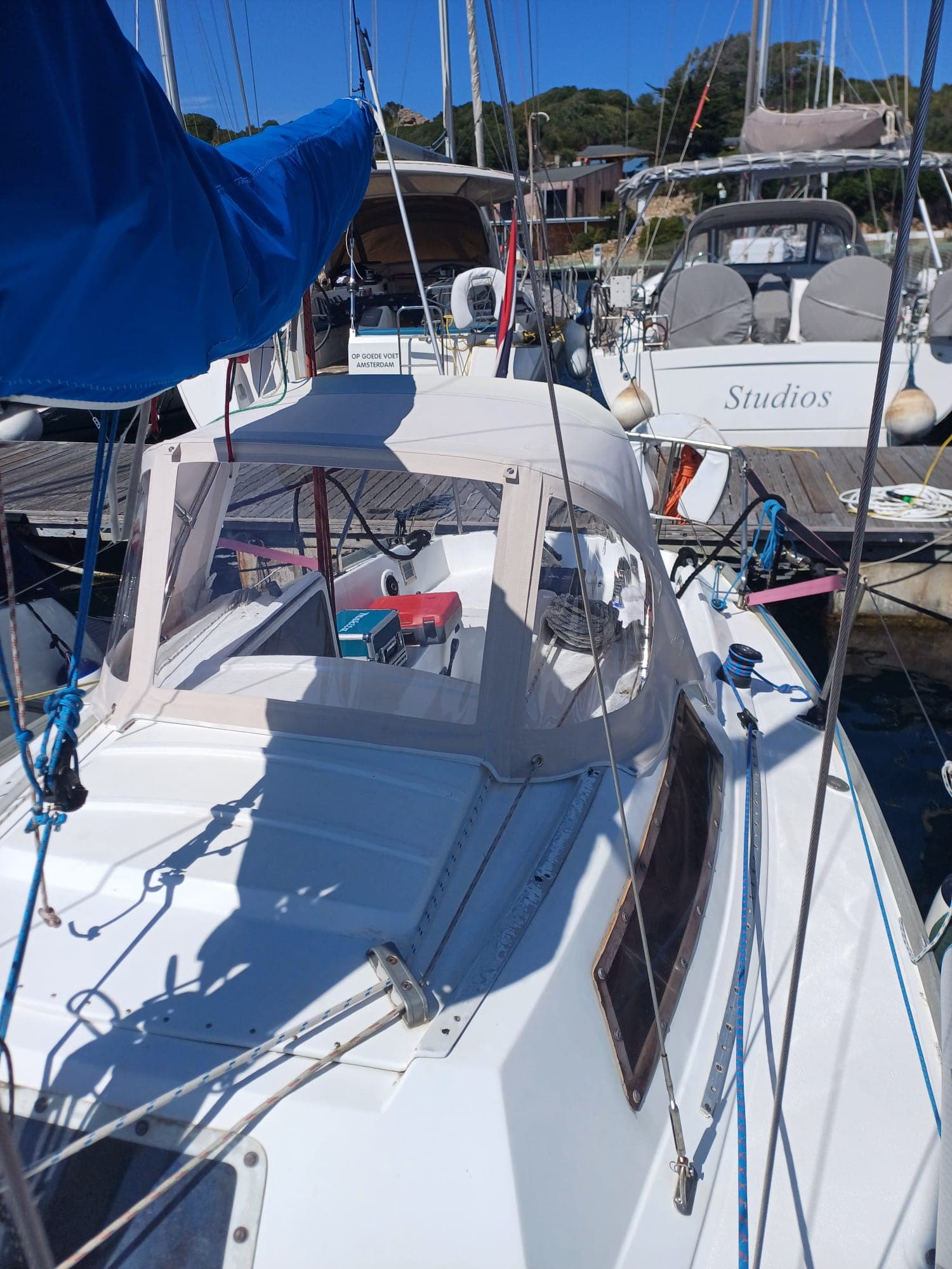 Sprayhood bianco su barca a vela, vista frontale in porto